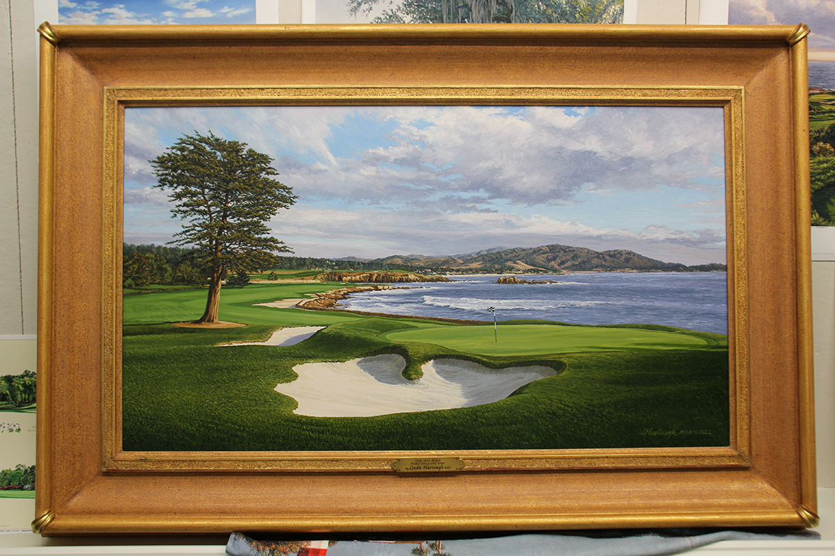 A framed painting of the 18th hole at Pebble Beach by renowned Hilton Head Island artist Linda Hartough